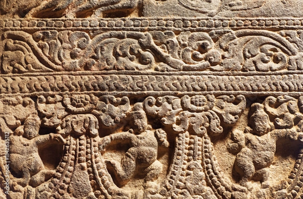 Fototapeta Stone patterns on ancient reliefs of abandoned temple in India. 