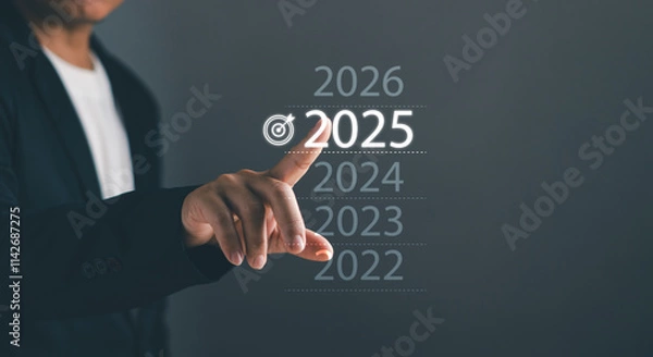 Fototapeta Business goal and vision for 2025.Performance goals for success Concept. Businessman touch 2025 with finger show business start up, strategies and processes for organization operations in new year