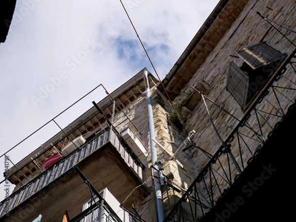 Fototapeta Gutters and electrical cables in a group of houses in a mountain village in the French Maritime Alps