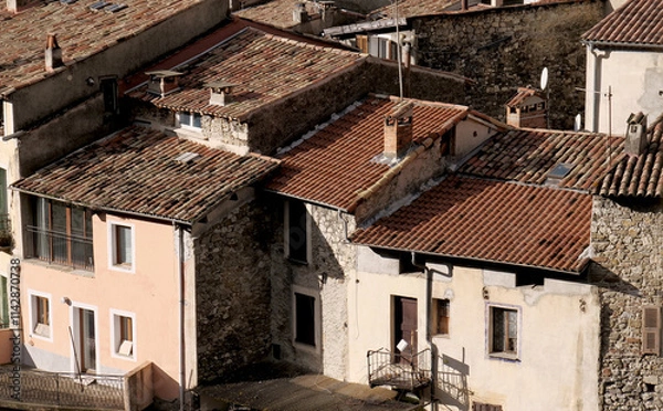 Fototapeta Red tile roofs and chimneys in a French mountain village near the Maritime Alps
