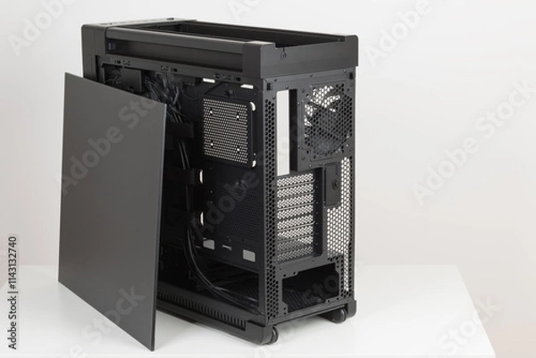 Fototapeta Side view of empty  big tower, PC case, chasis, without upper , left metal panel  and  tempered-glass right  panel. At the bottom is a cover for power supply unit