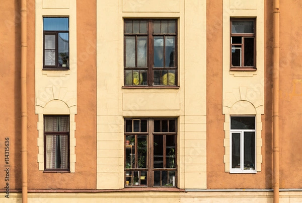Fototapeta Several windows in a row on facade of urban apartment building front view, St. Petersburg, Russia.