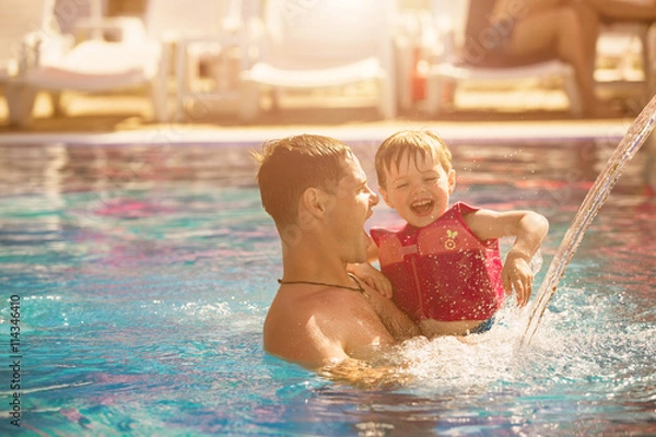 Obraz Father playing with son in pool