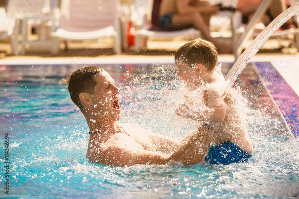 Obraz Father playing with son in pool