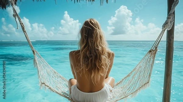 Obraz Woman relaxing in hammock over turquoise ocean.