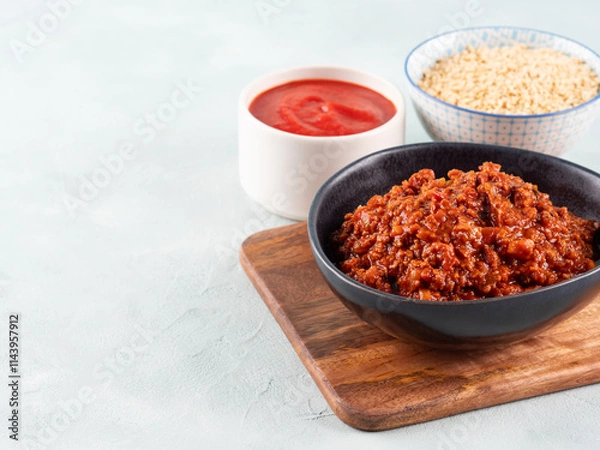 Fototapeta Vegan tomato bolognese ragu with soya protein granules in bowl