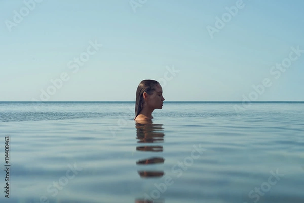 Fototapeta Beautiful elegant woman in the sea