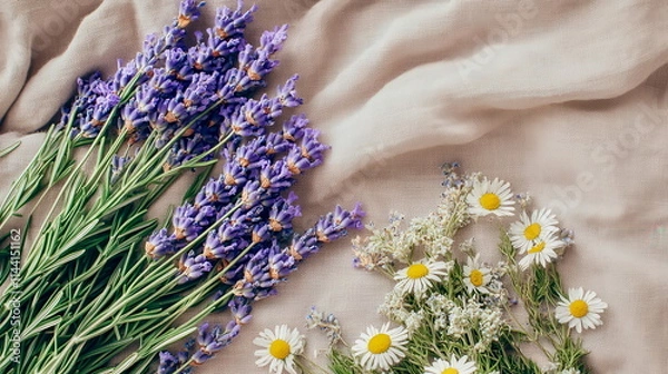 Obraz An artistic flat lay of lavender flowers, dried chamomile, and rosemary sprigs on a linen cloth