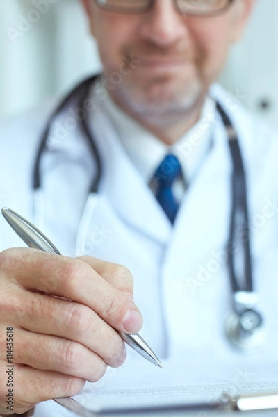 Fototapeta Male medicine doctor hand holding silver pen writing something on clipboard closeup. Ward round, patient visit check, medical calculation and statistics concept. Physician ready to