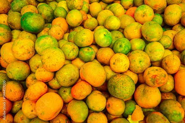 Fototapeta Orange citrus fruits in a fruit shop basket. Focus on fruit, noisy, exposure, similar others