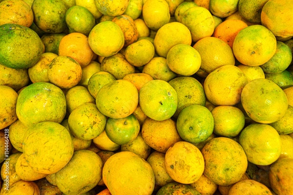 Fototapeta Orange citrus fruits in a fruit shop basket. Focus on fruit, noisy, exposure, similar others