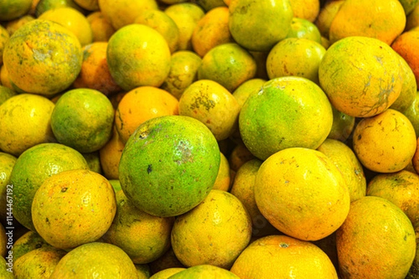 Fototapeta Orange citrus fruits in a fruit shop basket. Focus on fruit, noisy, exposure, similar others