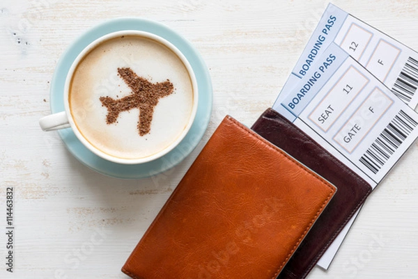 Fototapeta Boarding passes, passports and coffee with aircraft made of cinnamon