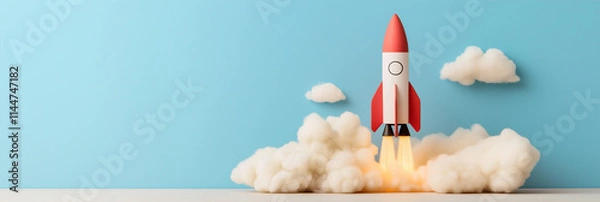Obraz A brightly colored toy rocket takes off with billowing clouds around it, reflecting dreams, imagination, and the spirit of adventure in a playful whimsical style.