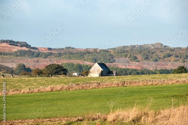 Fototapeta Stone farm building in a field