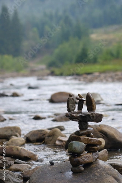 Fototapeta Unusual figurine made of river pebbles.
