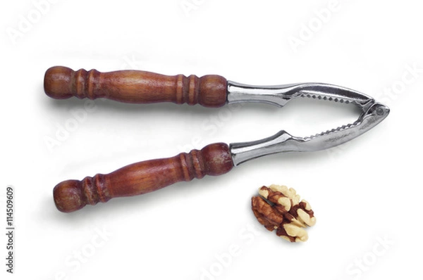Fototapeta Walnut kernel and nutcracker isolated on a white background. Top view