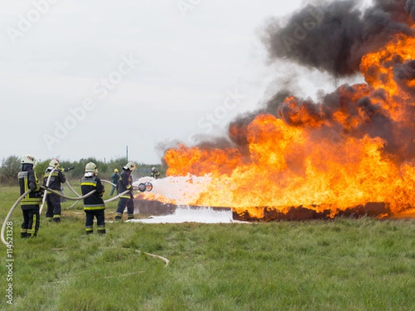 Obraz Fighting fire with a foam extinguisher