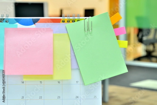 Fototapeta Colorful of sticky notes on calendar at business office with copy space for text.