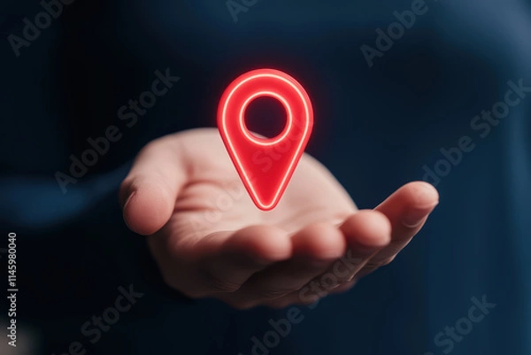 Obraz hand holding glowing red location pin symbol, representing navigation and mapping