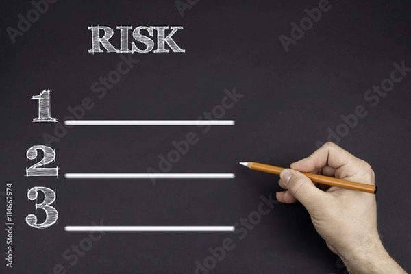Obraz Hand with a white pencil writing: Risk blank list