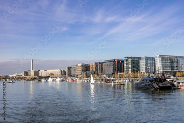 Fototapeta View from the ferry between Washington DC and Alexandria, showcasing a scenic waterfront and modern cityscape.