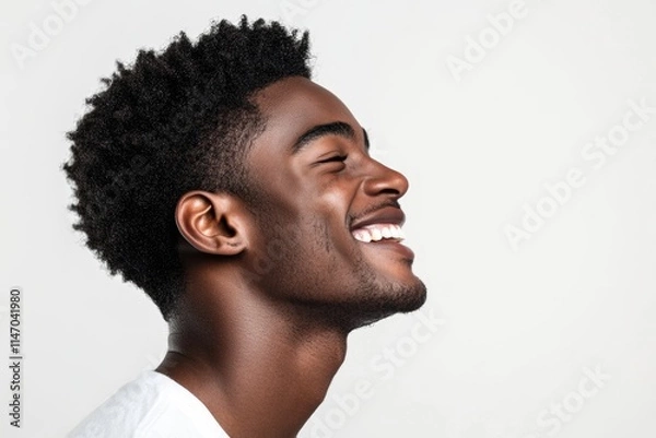Fototapeta Close up profile portrait of handsome young black man laughing against isolated white background