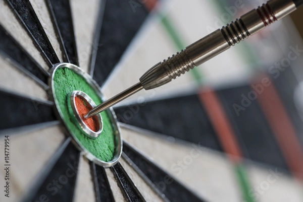 Fototapeta Single dart hitting bull's eye on the dartboard