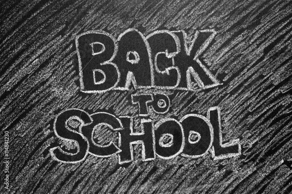 Fototapeta Back to school phrase written on blackboard