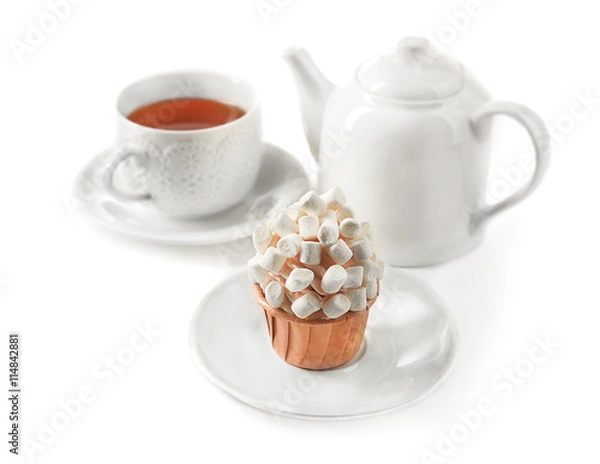 Fototapeta Cup of tea with tasty cupcake and teapot, isolated on white