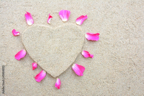 Obraz Heart shape and pink rose petal with sand background