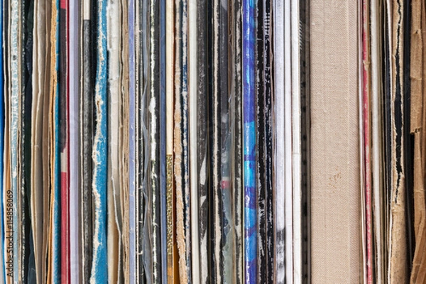 Obraz Retro styled image of a collection of old vinyl record lp's with sleeves on a wooden background. Copy space