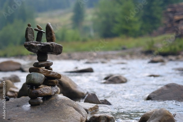 Fototapeta Unusual figurine made of river pebbles.