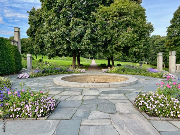 Fototapeta A stunning close-up of vibrant flowers in Vigeland Park, Oslo, Norway. The colorful blooms and lush surroundings highlight the serene beauty of this iconic park.