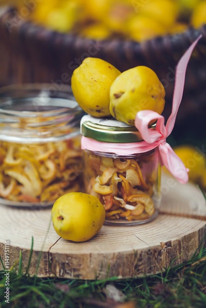 Obraz Freshly picked quinces and dried fruit slices in a rustic outdoor setting