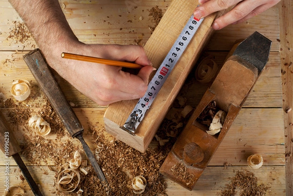 Obraz Carpenter working, hammer, meter and screw-driver on construction background
