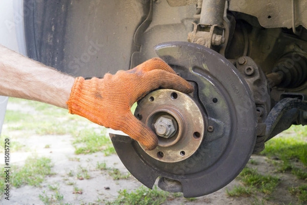 Obraz Man is repairing front suspender of a car
