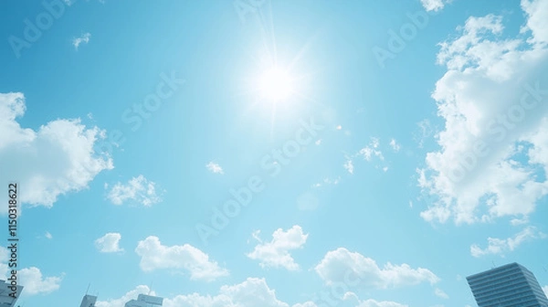 Fototapeta Sunny Day Sky with Clouds: A breathtaking view of a bright blue sky, punctuated by fluffy white clouds and a radiant sun, casting a warm glow over the cityscape.  