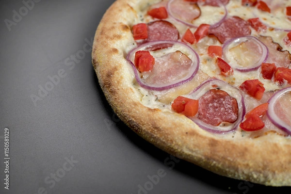 Fototapeta details of the pizza application; juicy pizza from the oven with mushrooms, tomatoes and bacon and sprinkled with parmesan cheese