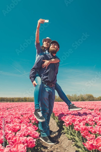 Fototapeta Taking selfie in tulip fields