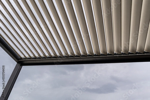 Obraz Aluminum pergola for outdoor patio against cloudy sky. Bottom view