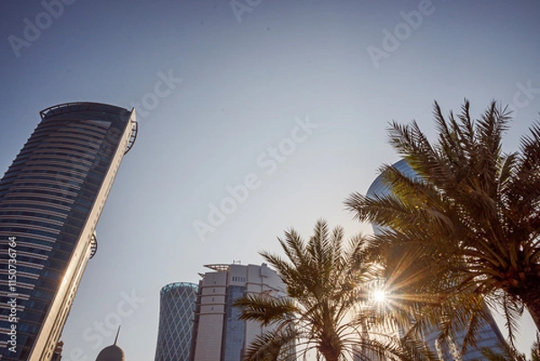 Obraz Bottom view of skyscrapers and tall buildings in Doha, Qatar with wide angle sky