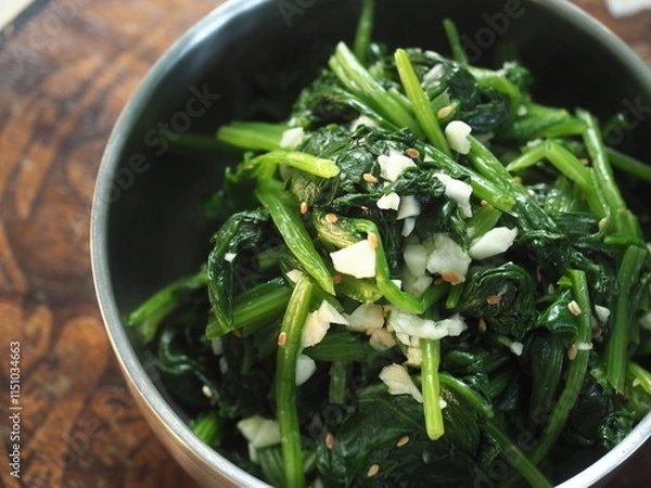 Fototapeta spinach with sesame seed and fresh garlic