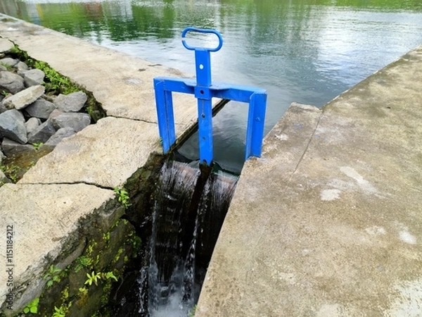 Fototapeta Blue Metal Water Gate Controlling Canal Flow in Outdoor Setting