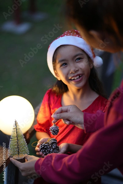 Obraz Daughter and mother are happy to join the Christmas day.