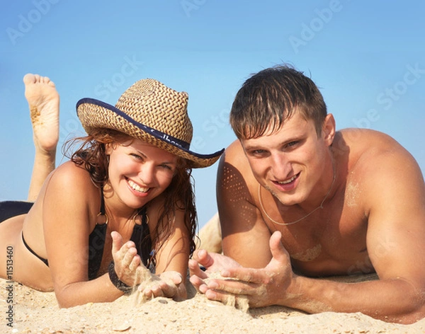 Obraz boy and girl lay on sand