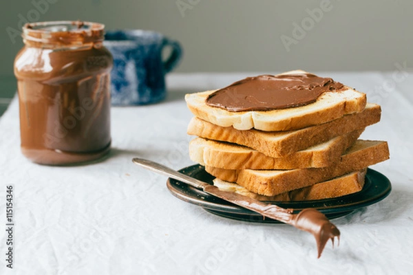 Fototapeta Slices of bread with chocolate cream. Close up.