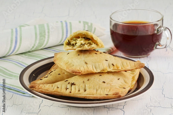 Obraz Homemade triangle pies with cheese and cup of tea