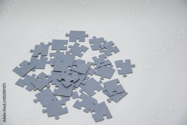 Fototapeta monochromatic puzzles in a pile lying on a white background