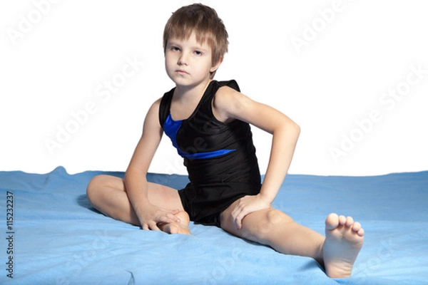 Fototapeta The boy does gymnastics